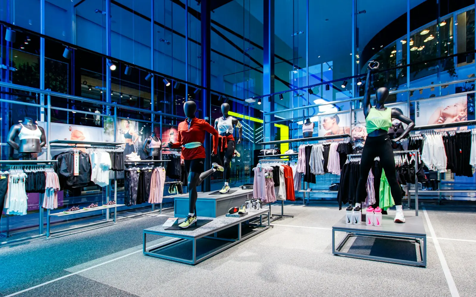 Clothing store interior with mannequins and blue-lit displays